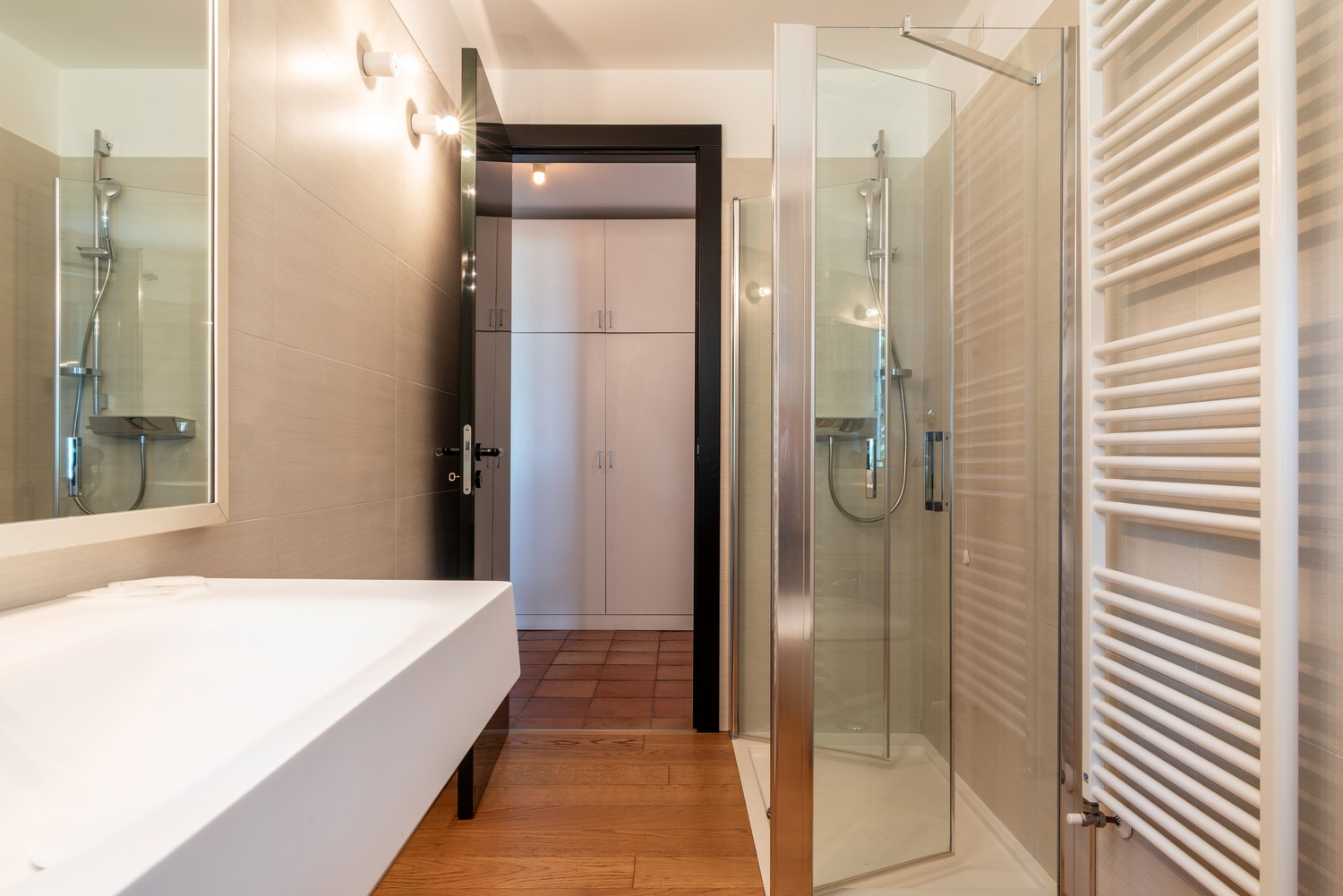 Corridor bath — vessel sink, the closets beyond