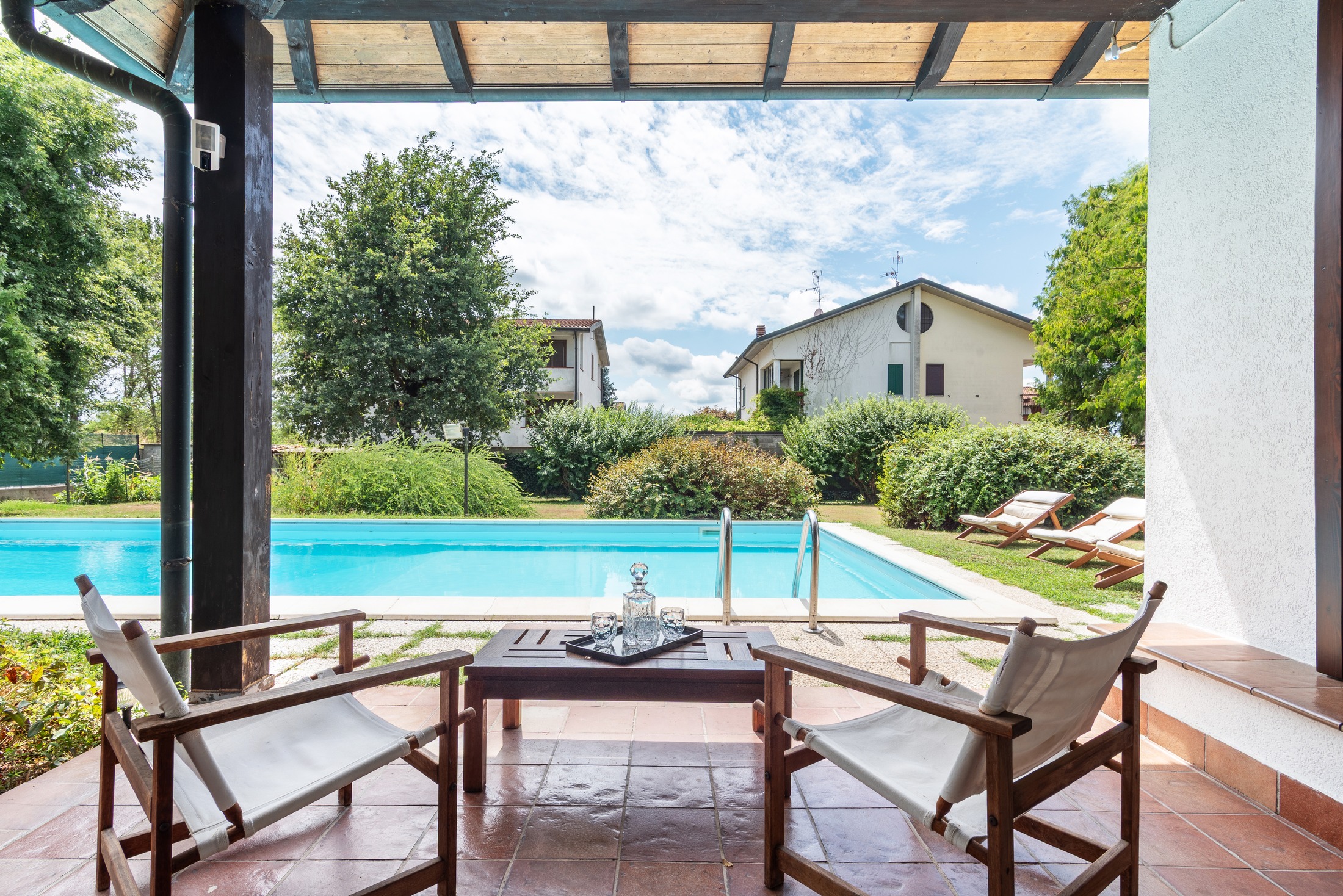 The pool — full length, lawn and chairs alongside