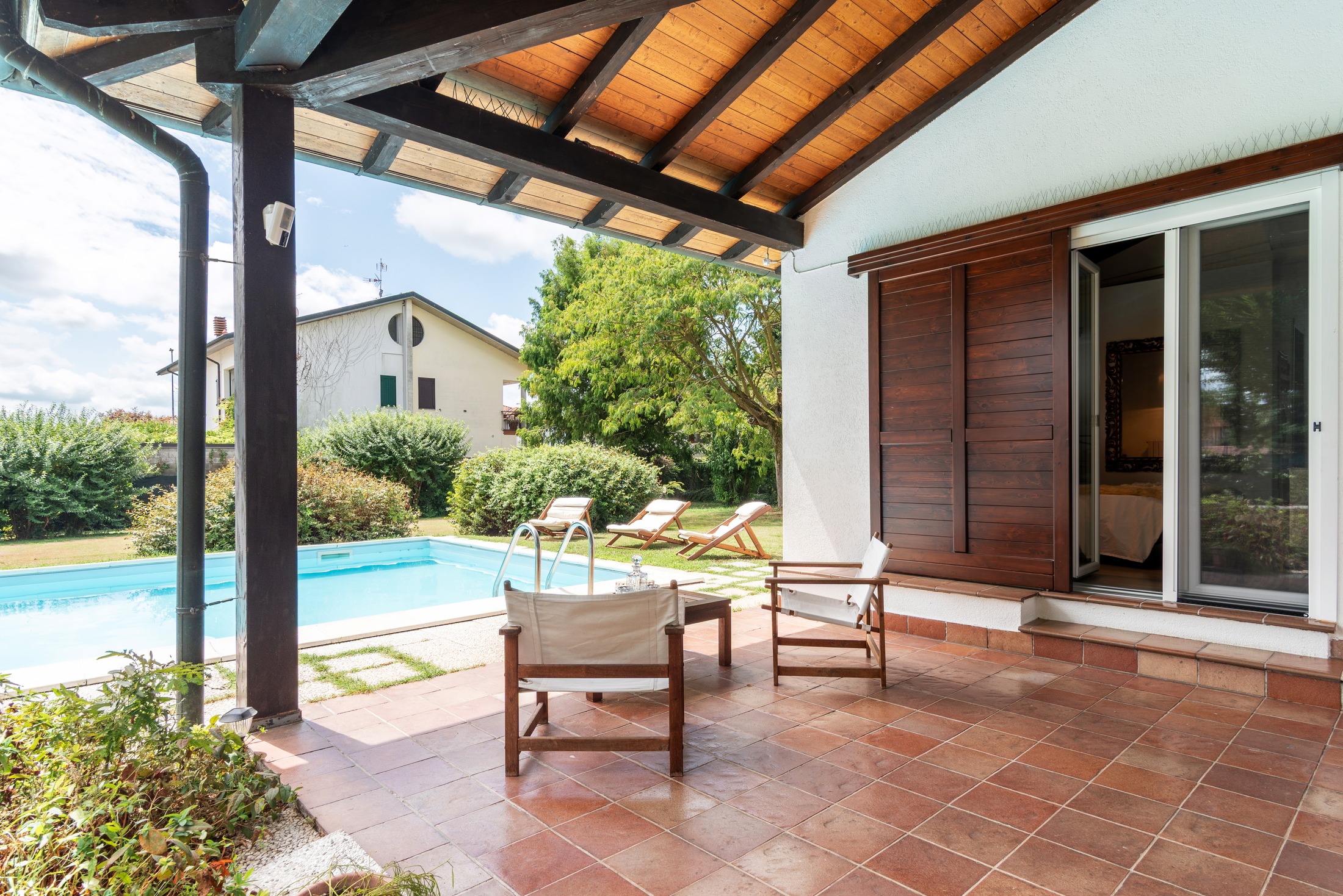 The pool from the pergola — the master bedroom door open