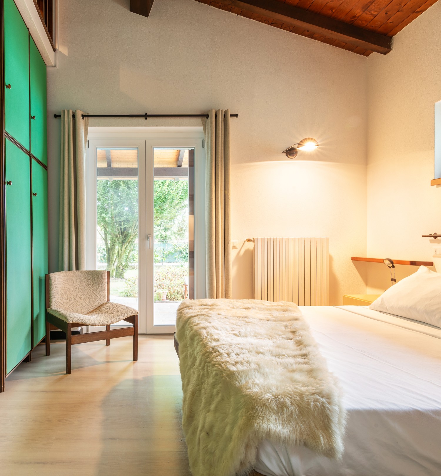 The green-wardrobe room — bed, French doors to the garden
