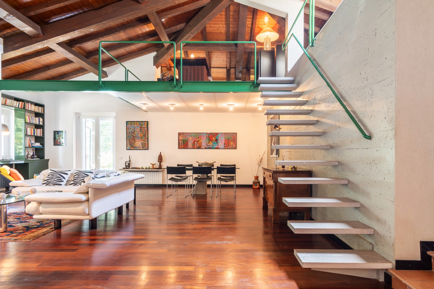 The great room — looking from the TV area toward the fireplace and dining
