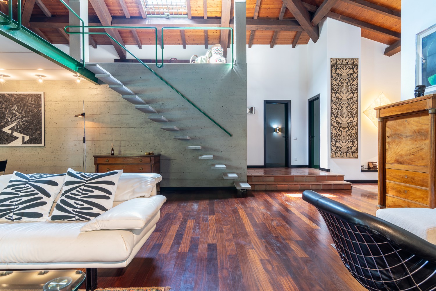 The great room — sofa, staircase, painting
