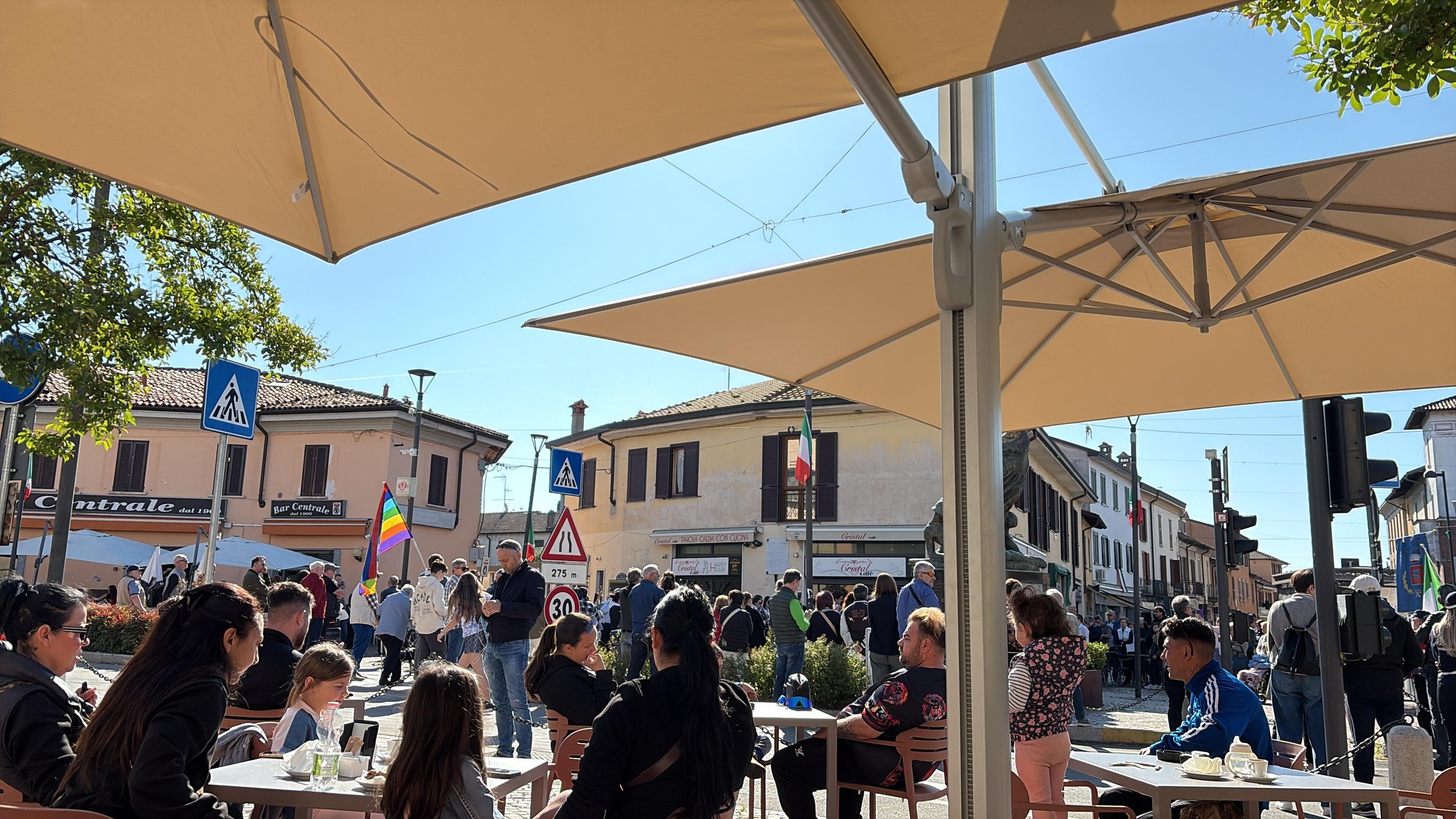 The piazza — Casorate Primo on a festival day, café tables and flags
